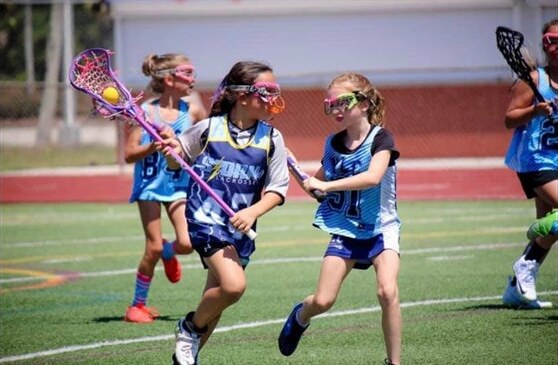 SWFL Storm players driving to the goal during a game
